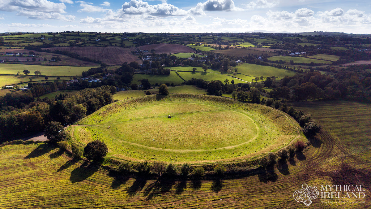 Aerial photograph of the Giant’s Ring at Ballynahatty, County Down, showing its sunlit circular earthwork, central passage tomb and long autumn shadows.
