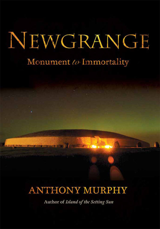 Image of the front cover of a book called Newgrange: Monument to Immortality. It shows a photograph of the Newgrange monument lit up at night, surrounded by the Nothern lights. 