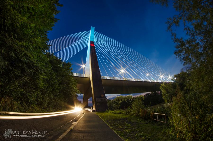 A car drives under the M1 Boyne Valley Bridge outside Drogheda at twilight.