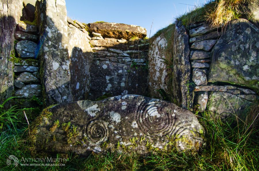 Spirals carved into a sill stone in the chamber of Cairn H, Carnbane West, Loughcrew. These ancient designs were picked onto the surface of this stone some time around 5,000 to 5,500 years ago. Cairn H is one of the smaller passage-tombs on Carnbane, the westernmost hill of the Loughcrew complex in northwestern County Meath. The cairns here are less well-known than those on nearby Slieve na Calliagh, but are no less wonderful in design and decoration.