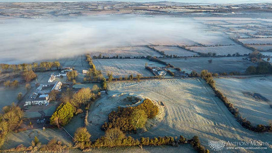The great megalithic mound of Dowth at Brú na Bóinne pictured in the early morning mist and frost.