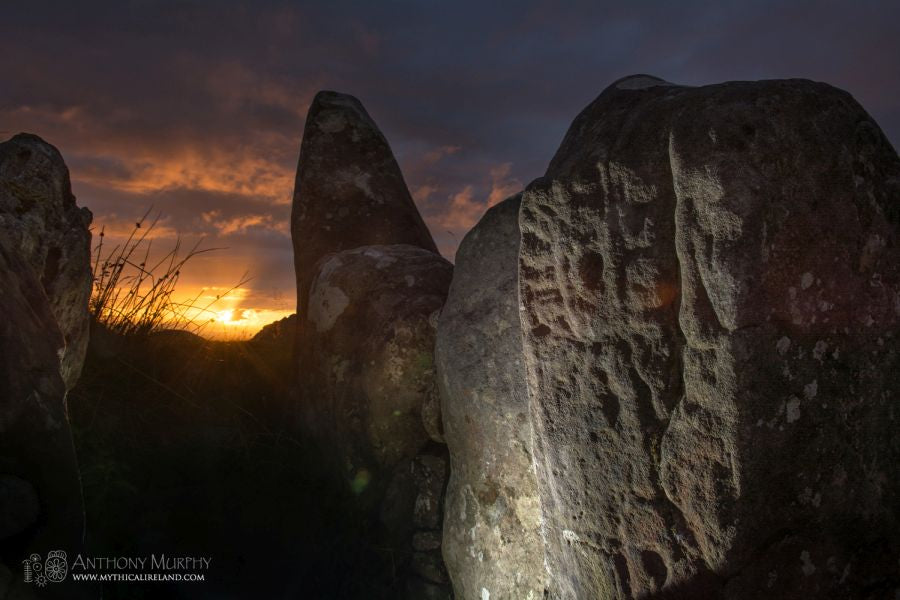 Lughnasa sunset at Cairn S, with its passage stones illuminated. Cairn S is one of just three cairns at the Loughcrew complex of Neolithic passage-tombs in County Meath whose passage points towards the western aspect. In the 1980s, Martin Brennan and his team of observers noted that Cairn S was aligned with the setting sun at Bealtaine in early May and Lughnasa in early August. These were the old cross-quarter days, the halfway points (in days) between the solstices and the equinoxes. 