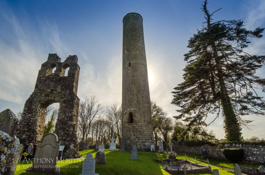 Donaghmore Round Tower, near Navan, Co. Meath, is located not far from the Boyne River. The tower in the 18th century had a conical top, with four windows underneath, near the top of the tower. A local landowner made alterations in 1841, presumably removing the cone-shaped top and blocking up any openings. A cross fragment in the National Museum is probably from Donaghmore.