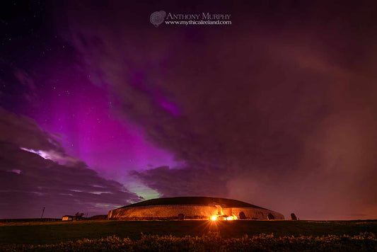 A beautiful display of northern lights between the clouds over Newgrange