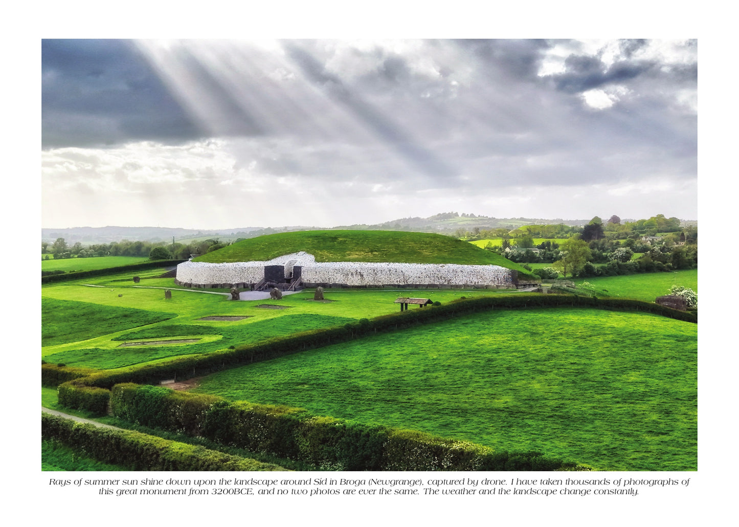Newgrange passage tomb beneath dramatic sunbeams