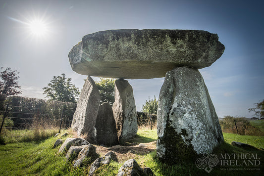 Ballykeel Dolmen in County Armagh, with sunlight forming a starburst above its massive capstone and lichen-covered upright stones. Photograph by Anthony Murphy.