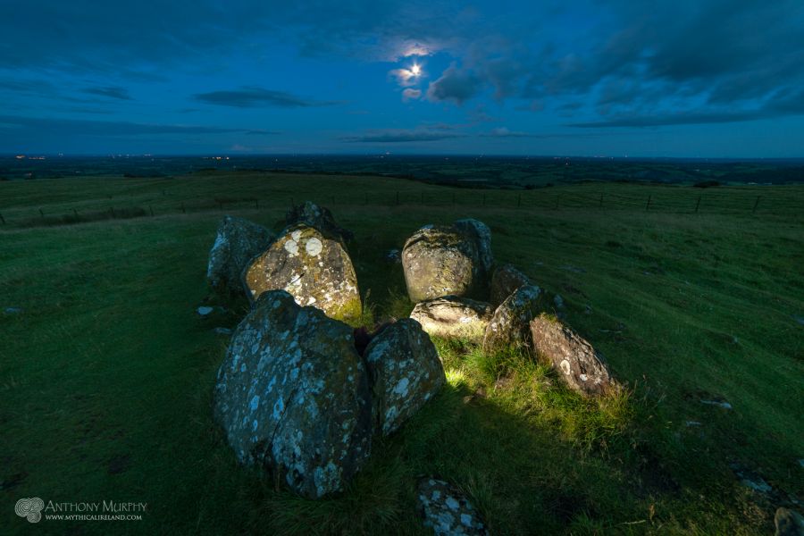 Moonrise over the remnants of Cairn V, Carnbane East, Loughcrew, at twilight.
